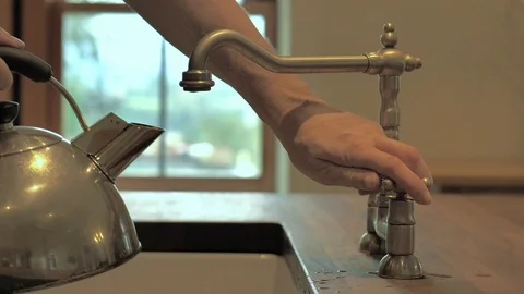 Man fills a kettle Stock Footage 116902301