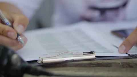 A man fills out documents or a questionnaire, a man's hands close up Stock Footage 137194288