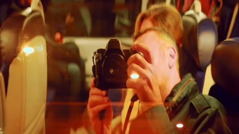 Man filming his reflection in the train window in the evening Stock Footage 295643327