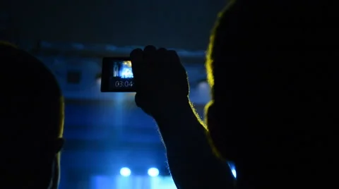 Man Filming Show on His Cell Phone. Stock Footage