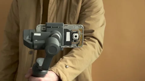 Man filming with a smartphone using a gimbal stabilizer Stock Footage 250194826