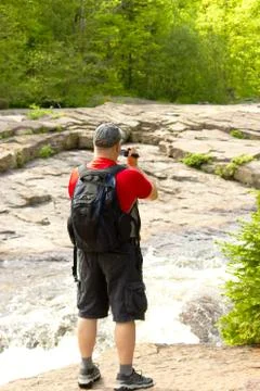 Man filming the stream Stock Photos