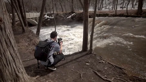 Man filming waterfall Stock Footage 106546661