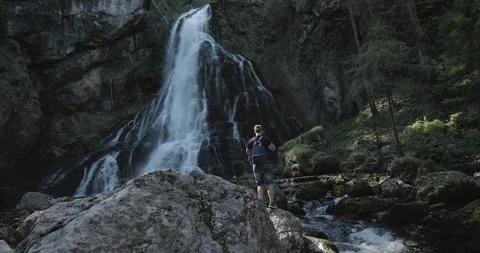 Man films Waterfall Stock Footage 211813073