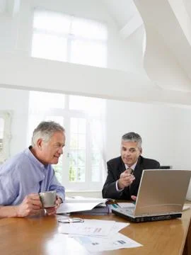 Man With Financial Advisor At Table Stock Photos
