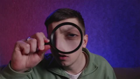 Man finding answer through lens and celebrating with joy Stock Footage 333757049