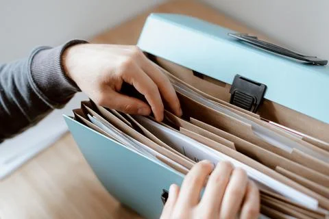 Man finding documents in a file Stock Photos