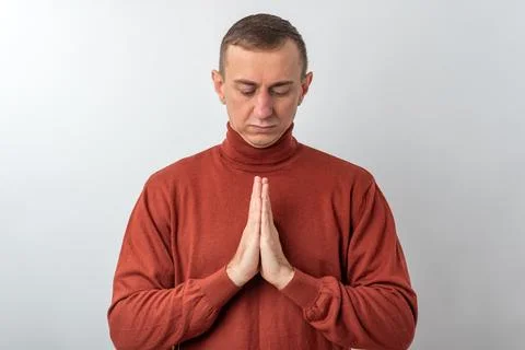 Man finding inner peace and spiritual connection, standing with hands press.. Stock Photos