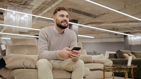 Man finding inspiration for home design, browsing online for furniture choices Stock Footage 334654194