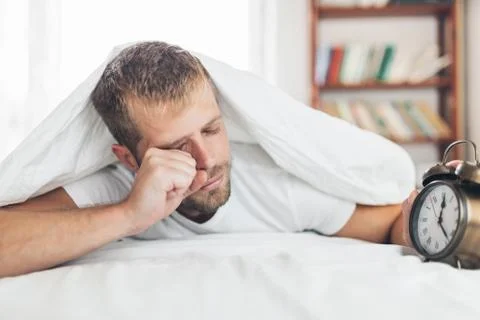 Man finding it difficult to wake up in the morning Stock Photos