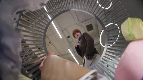 Man Finding Lost Sticky Note in Trash Can Stock Footage 343707663