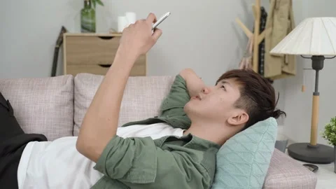 Man finding nothing fun on the smartphone Stock Footage 161813116