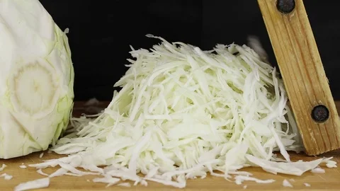 A man finely rubs the cabbage Stock Footage 121661296