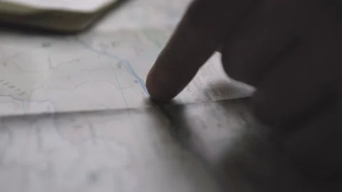 Man finger Plans Trip On Map Stock Footage
