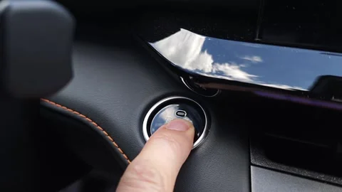 Man finger presses the red push start button in a sports car. Drive your dream Stock Footage 278101488