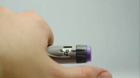 Man Finger Pushing The Button Of A Special Diabetes Syringe, Over Dose Stock Footage 47656261