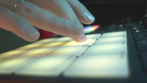Man finger taps button conducting laser show at discotheque Stock Footage 268425402