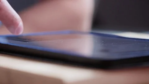 Man finger touching scroll page tablet. Browsing movie in internet watch online Stock Footage 80008283