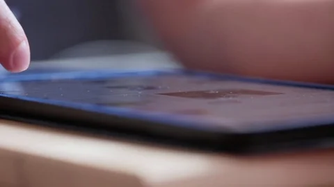 Man finger touching scroll page app on tablet. Browsing video in the library Stock Footage 80008310