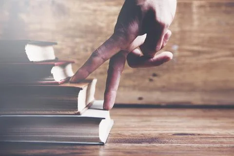 Man fingers on books Stock Photos
