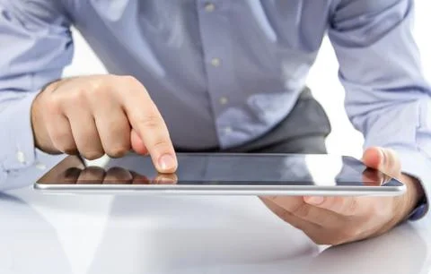Man fingers touching screen on digital tablet Stock Photos