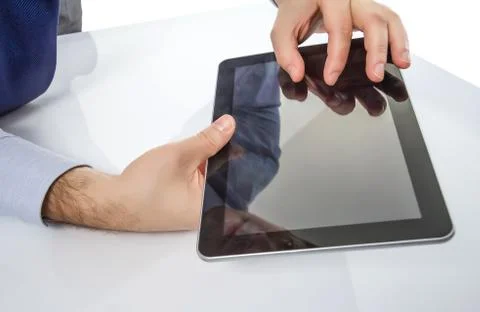 Man fingers touching screen on digital tablet Stock Photos