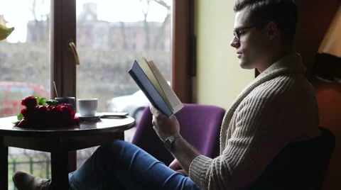 Man finish reading book in the cafe and relaxing Stockbeeldmateriaal 48715122