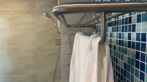 Man finish shower inside bathroom, pull white towel from rack Video stock 247458054