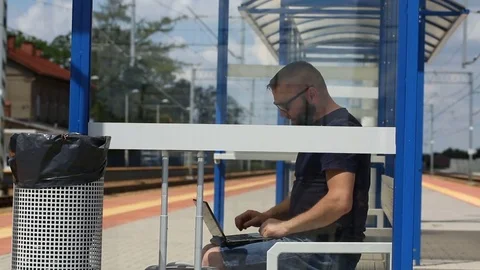 Man finish using laptop on the platform and leaving the stop Stock Footage 78654467
