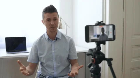Man Finishes Explaining Something While Recording Himself Stock Footage 135029983