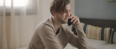 A man finishing the conversation with someone over the phone, work from home Stock Footage 135096489