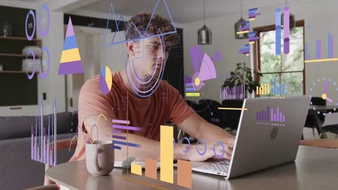 Man finishing notes, moving to laptop and typing while charts overlaying table Stock Footage 333609869