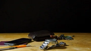 Man finishing Work and throws keys and wallet on table, gets home  Stock Footage 85679447