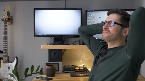 A man finishing work at a remote workplace. A freelance person who has a coffee Video stock 129992707