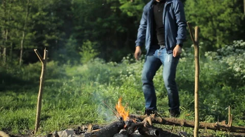 Man fire up campfire Stock Footage 64049277