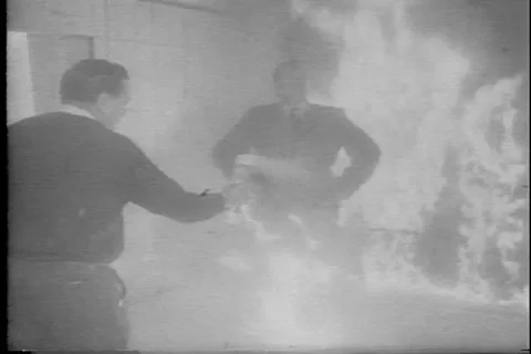 Man on Fire demonstrating fire-resistant business suit fabric - archival footage Stock Footage 134222787