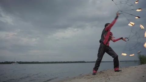 A man with fire on the river Stock-Footage 115054124