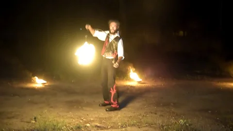 Man firejuggling at night Stock Footage 128971803