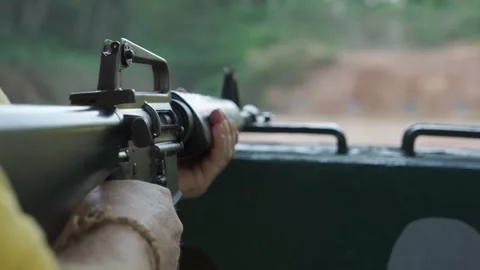 A man fires an mounted M16 rifle at the War Museum in Ho Chi Minh City Stock Footage 293343879