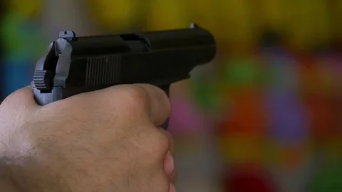 A man fires a pneumatic gun at a target in a slowed pace Stock-Footage 82225571
