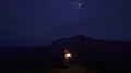 The man with a firework stick standing on the night mountain 4k or 4k+ Resolution