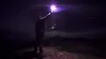 The man with a firework stick standing on the night mountain 4k or 4k+ Resolution