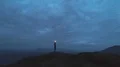 The man with the firework stick standing on the night mountain 4k or 4k+ Resolution