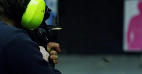 Man firing automatic machine gun in slow motion Stock Footage 45976070