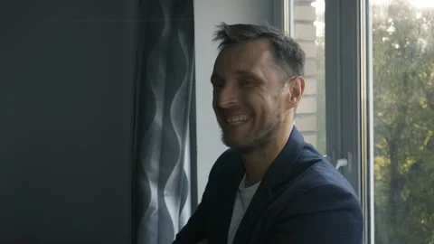 The man first laughs then puts his finger to his lips Stock Footage 156049709