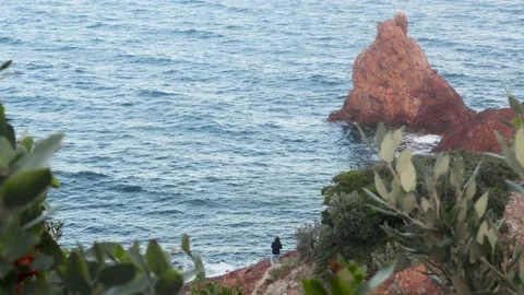 Man with a fish rod casts the hook in the sea Stock Footage 165068986