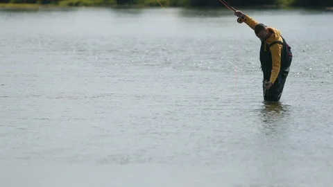Man fisherman throws a float, caught a fish by hand in the river 스톡 동영상 114560252