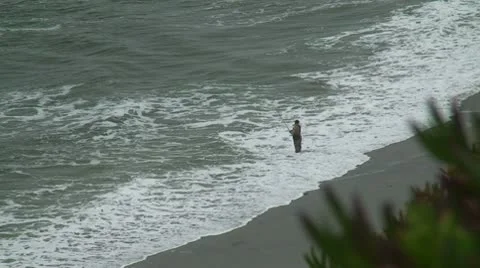Man fishing on beach Stock Footage 10744451