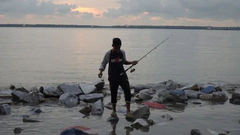 A man fishing at beach side. Stock Footage 99795866