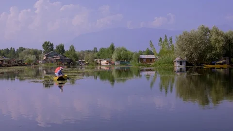 Man Fishing in a Boat 4K on Dal Lake, Srinagar, India Stock Footage